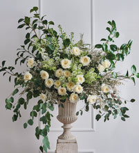 Arrangement of Patience roses with Charming milky buds ruffle out into ivory sculpted cups of delicate, lace-like petals revealing a creamy colored centre with just a hint of pale, buttery yellow.