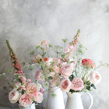 Pitchers of Keira roses and greenery - Frilly wedding-dress petals frame her cupped blooms in every shade of soft pink, from raspberry ripple to clotted cream.
