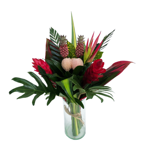 glass vase of pink, green, and beige tropical bouquet of (3) Ginger Pink, (2) Sassy, (2) Ananas, (3) Pandanus, (1) Croton Pecoso, (2) Arrow Palm, (3) Xantal, (5) Cordelines Leaves, (2) Masajeanas, (1) Anglonema, (2) Lettuce Ferns.