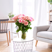 bouquet of ts ruffled edges and light pink cream tones with darker pink on the outer petals 
